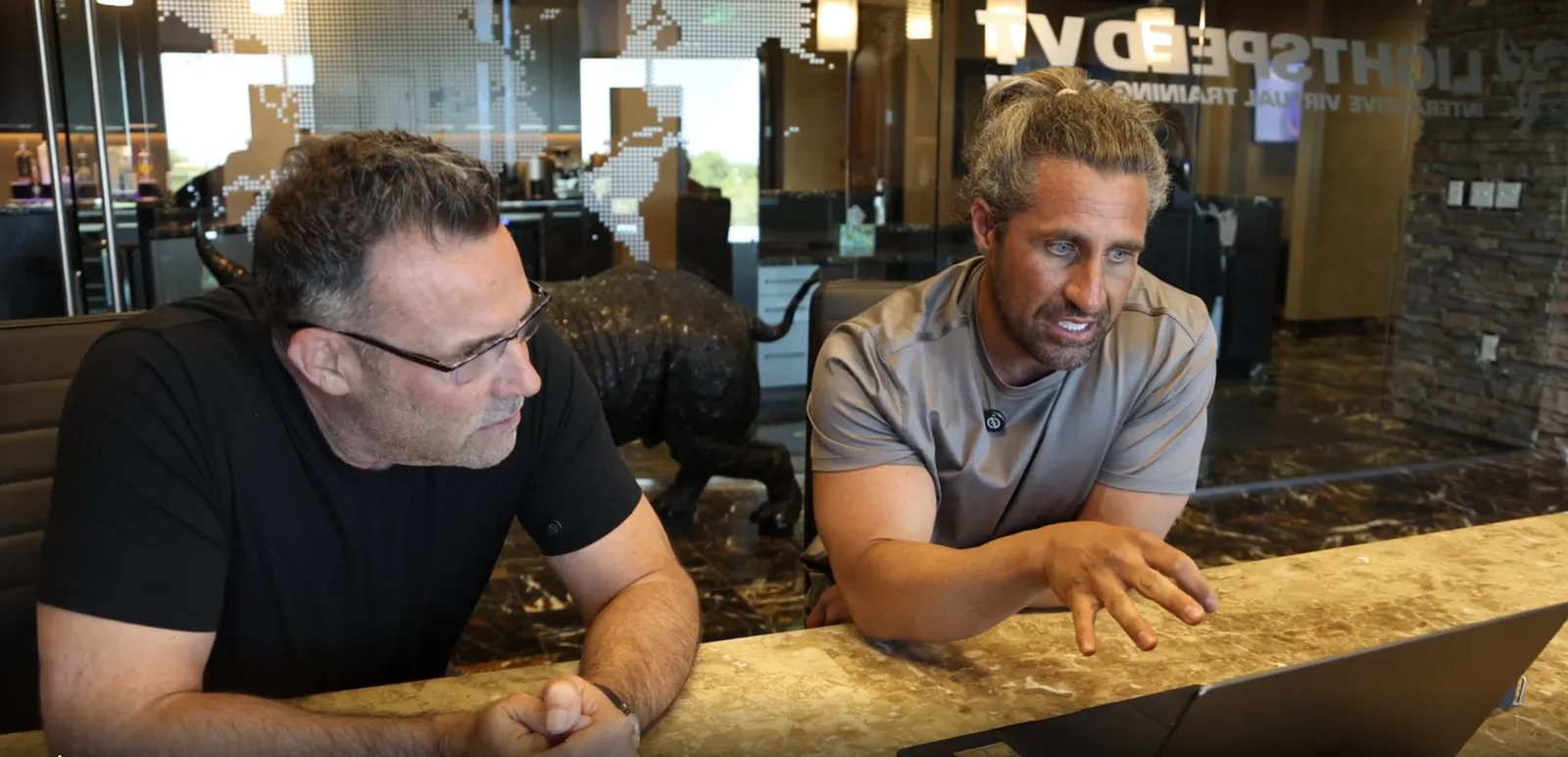 Brad Lea and Zack Memmott at a laptop on the Dropping Bombs set