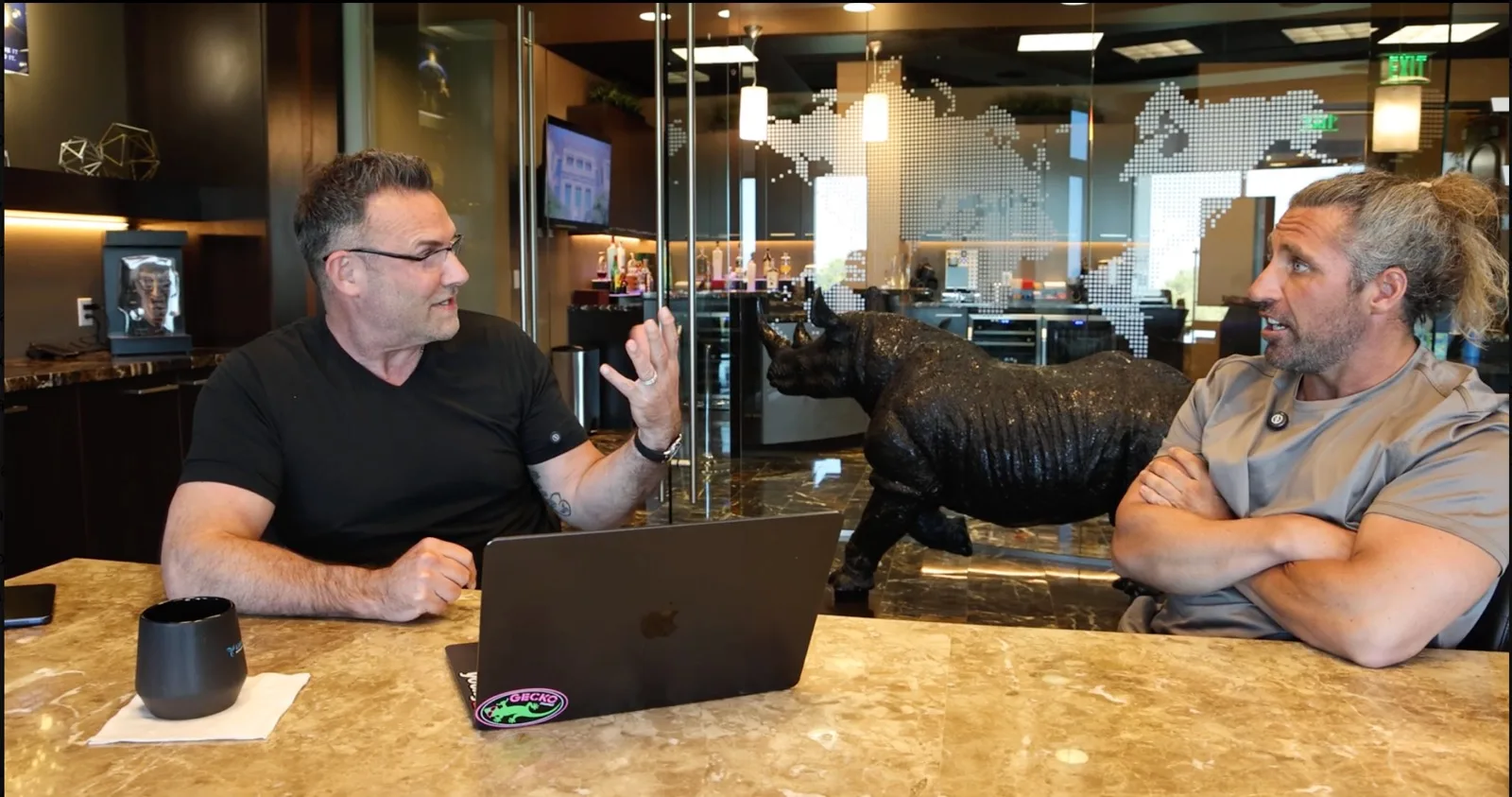 Brad Lea talking with Zack Memmott across the desk
